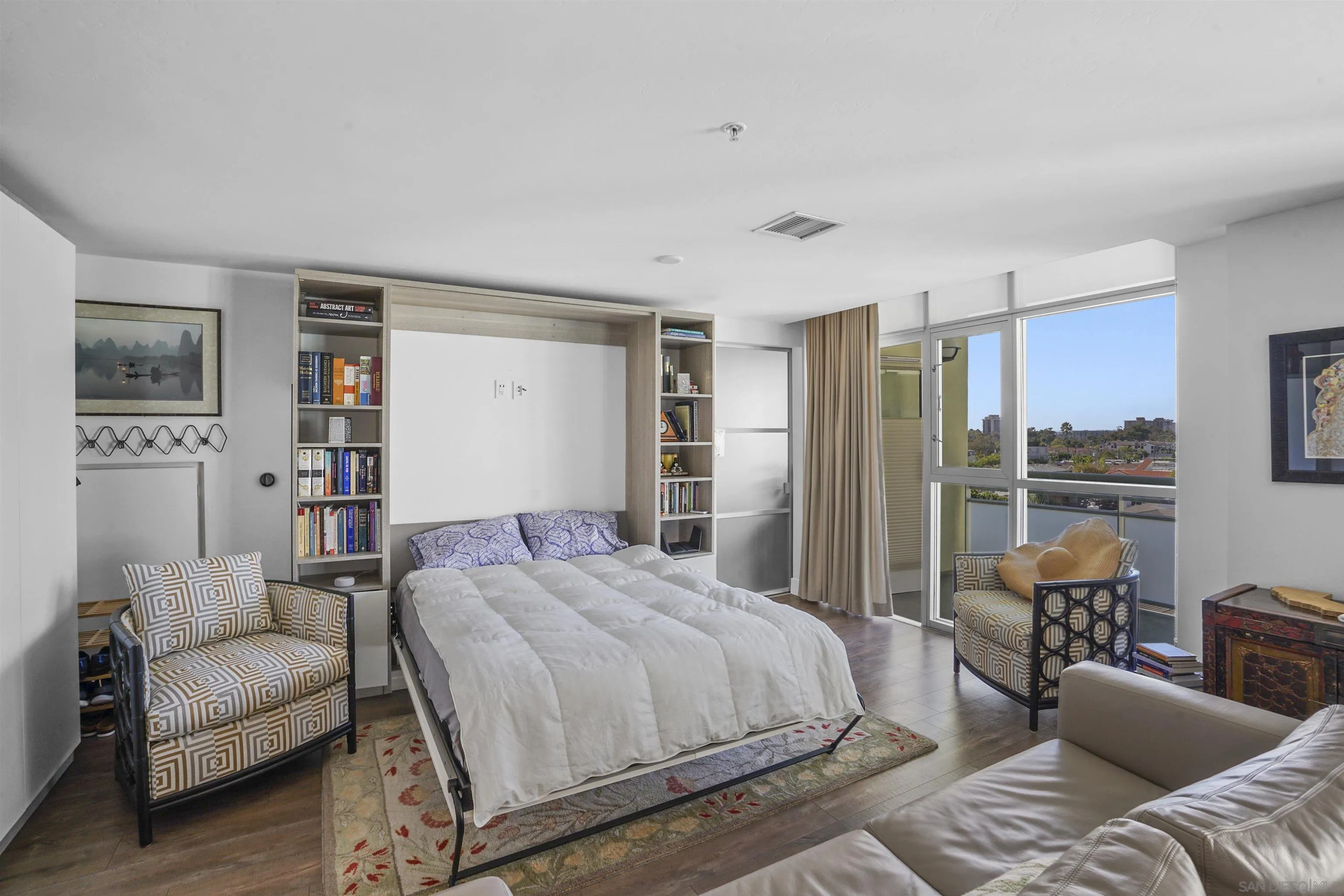 3812 Park Boulevard, Unit 503 San Diego, CA 92103 - Photo 7 of 27 a spacious bedroom with a bed a couch and a large window