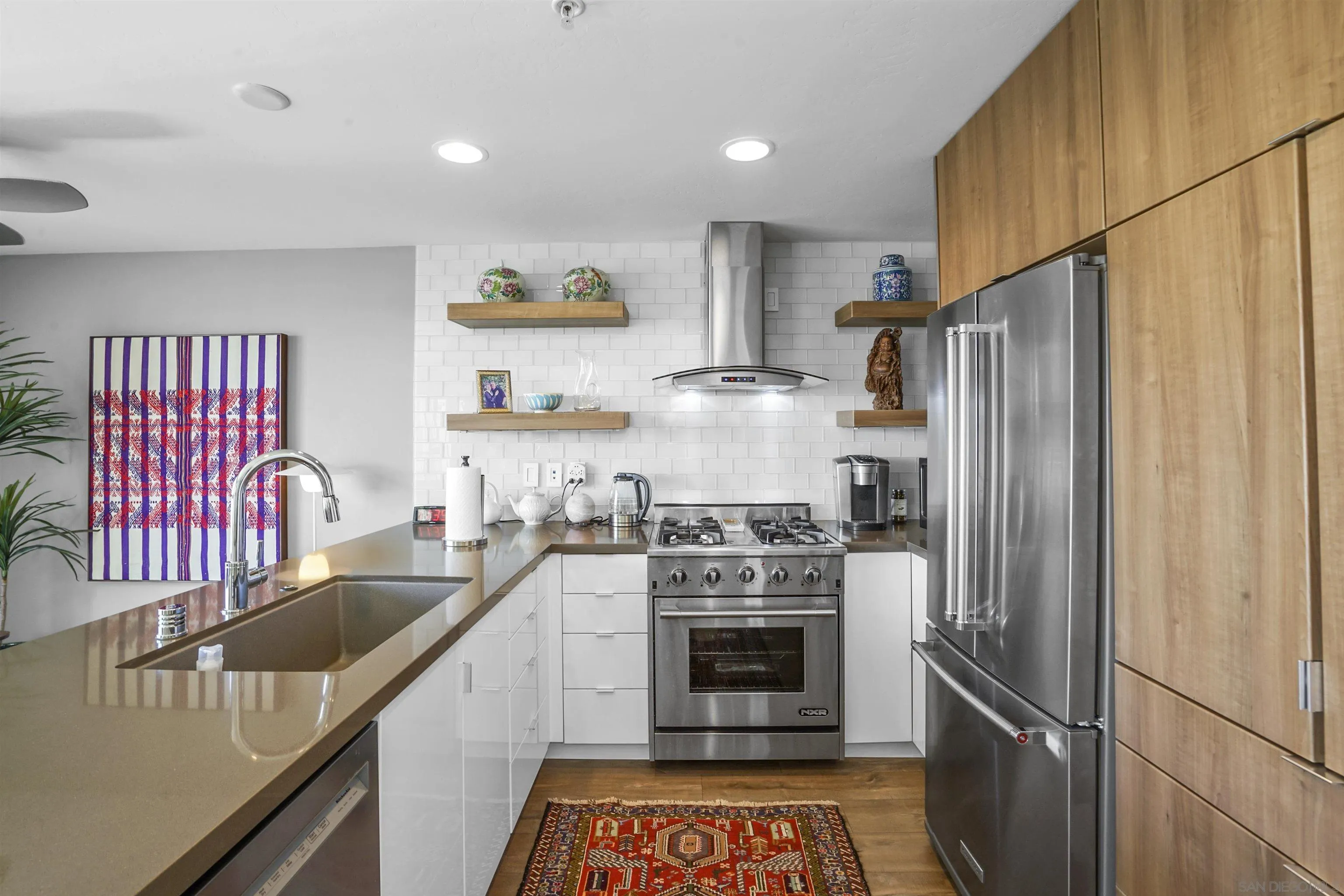 3812 Park Boulevard, Unit 503 San Diego, CA 92103 - Photo 10 of 27 a kitchen with stainless steel appliances granite countertop a refrigerator sink and stove