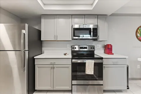 a kitchen with white cabinets stainless steel appliances and sink