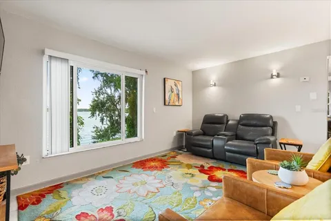 a living room with furniture and a baby crib