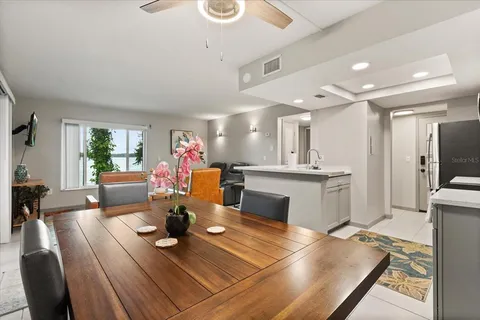 a living room with kitchen island furniture and a view of kitchen
