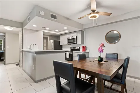 a kitchen with a dining table chairs and microwave