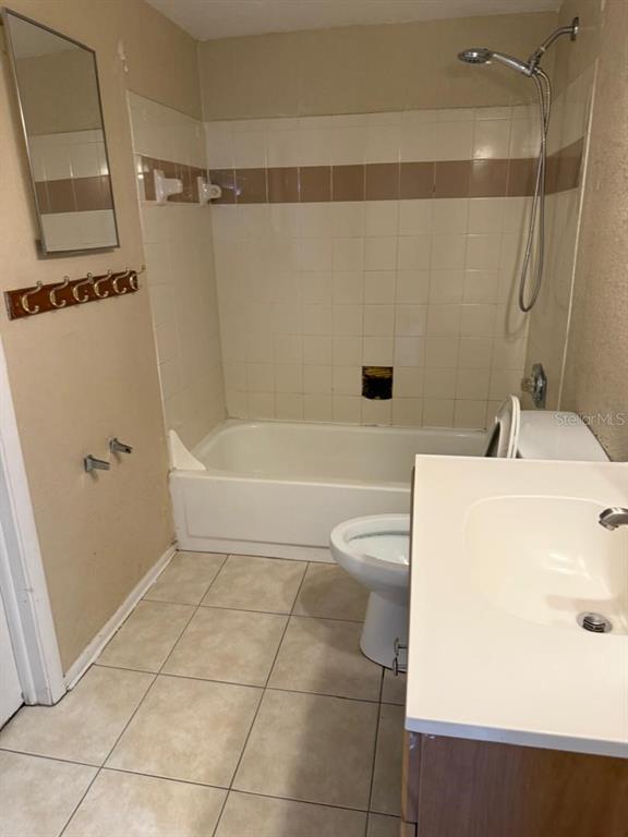 1908 Lake Atriums Circle, Unit 12 Orlando, FL 32839 - Photo 11 of 11 a bathroom with a sink a toilet and shower