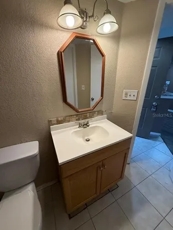 a bathroom with a sink vanity and a mirror