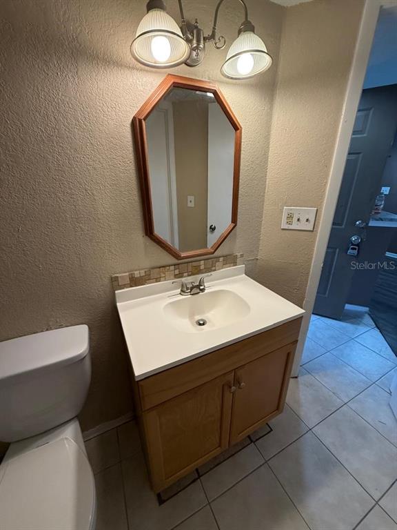 1908 Lake Atriums Circle, Unit 12 Orlando, FL 32839 - Photo 8 of 11 a bathroom with a sink vanity and a mirror