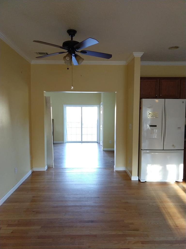 136 Britton Road Windsor, SC 29856 - Photo 8 of 60 a view of a room with wooden floor a ceiling fan and windows