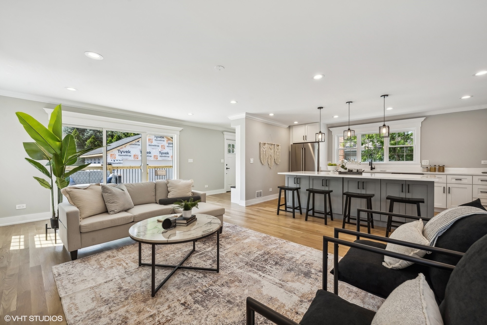 Undisclosed Address Elmhurst, IL 60126 - Photo 19 of 53 a living room with furniture a dining table and a potted plant