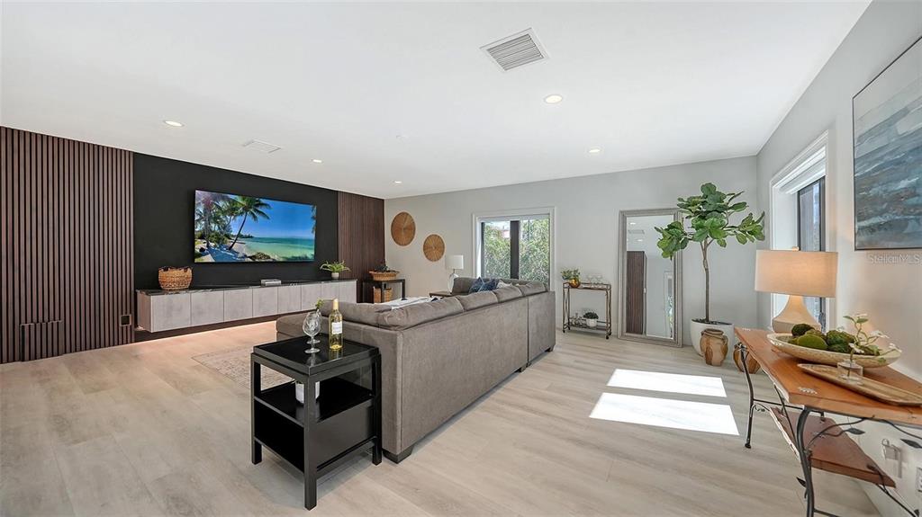 5035 Bay Shore Road Sarasota, FL 34234 - Photo 39 of 84 a living room with furniture and a flat screen tv