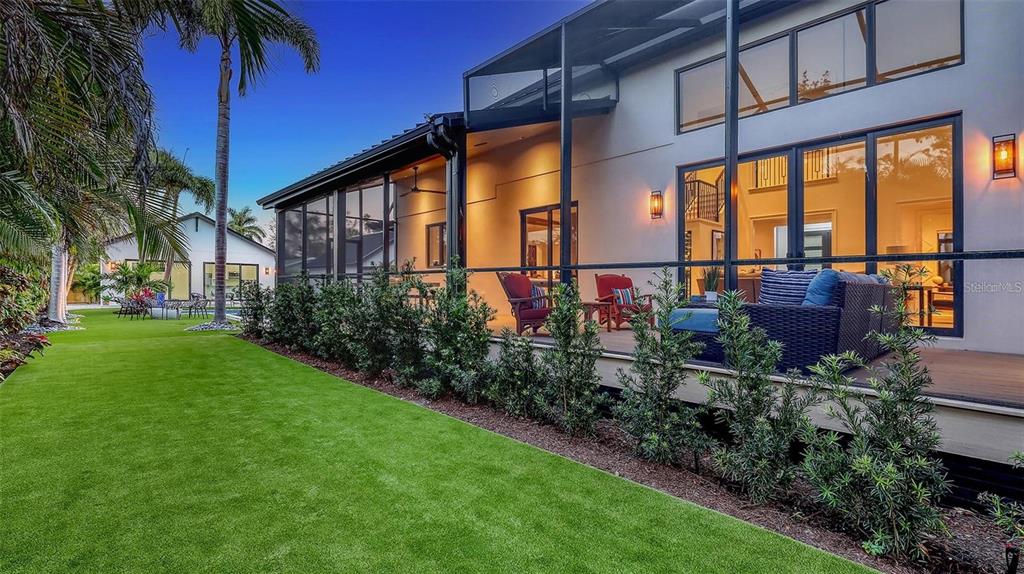 5035 Bay Shore Road Sarasota, FL 34234 - Photo 43 of 84 a view of a house with a small yard and floor to ceiling windows