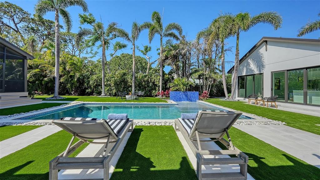 5035 Bay Shore Road Sarasota, FL 34234 - Photo 48 of 84 a swimming pool with outdoor seating and yard