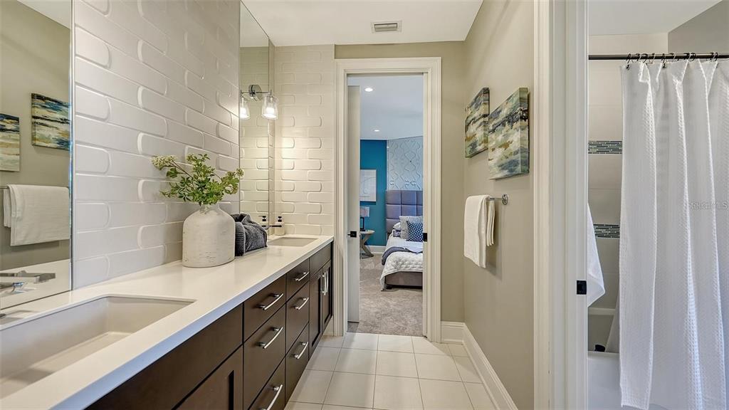5035 Bay Shore Road Sarasota, FL 34234 - Photo 53 of 84 a bathroom with a double vanity sink a mirror and a shower
