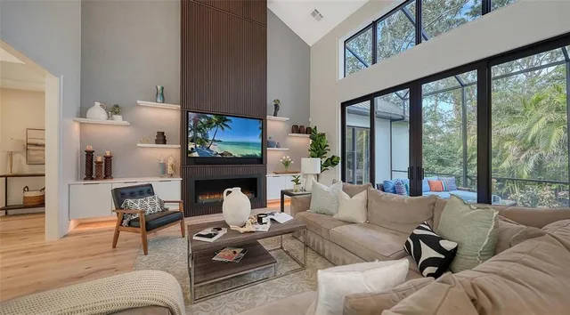 a living room with furniture potted plant and a large window
