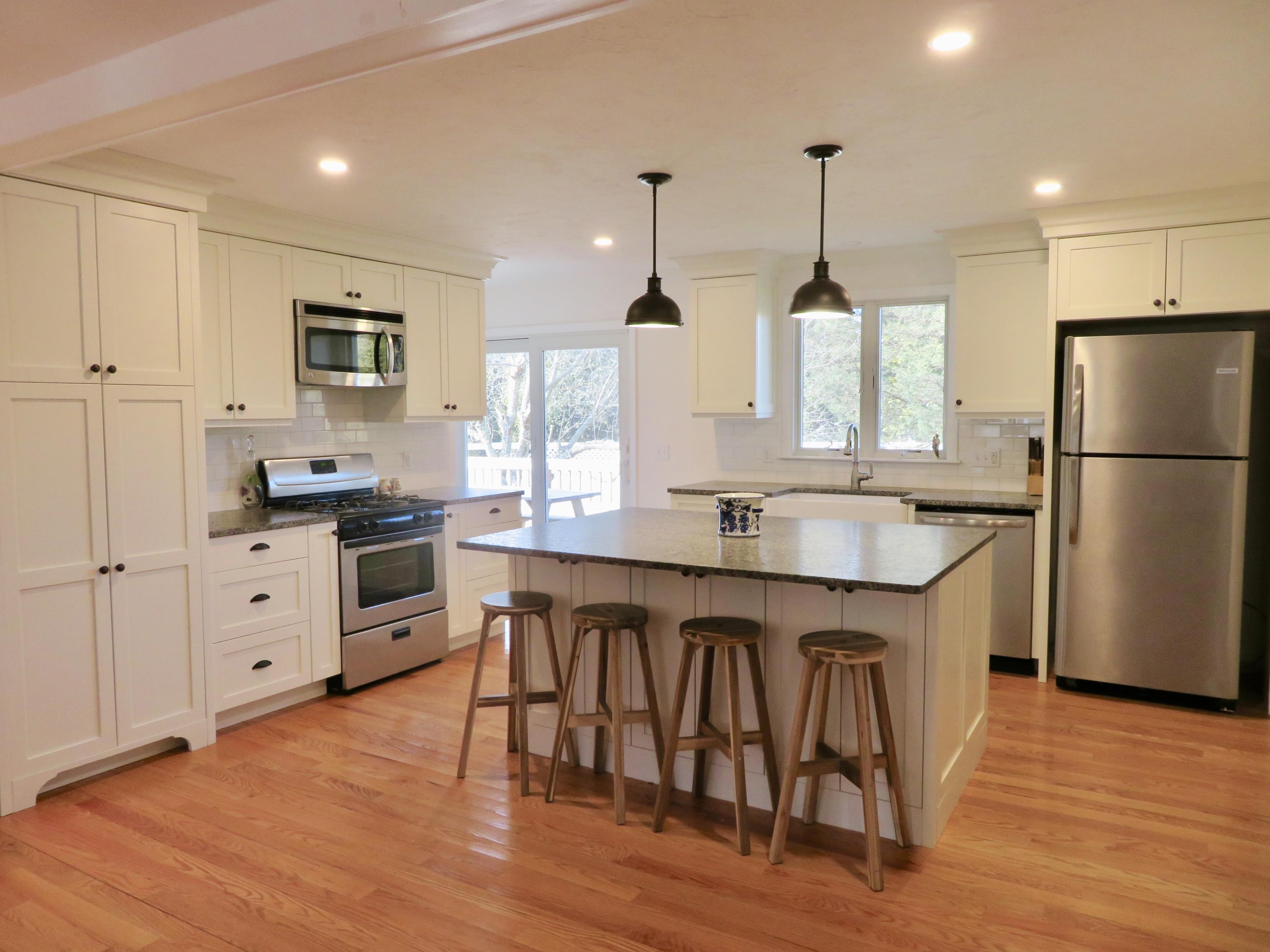 111 Elgin Road Pocasset, MA 02559 - Photo 1 of 34 a kitchen with stainless steel appliances granite countertop a refrigerator a sink dishwasher a stove and white cabinets with wooden floor