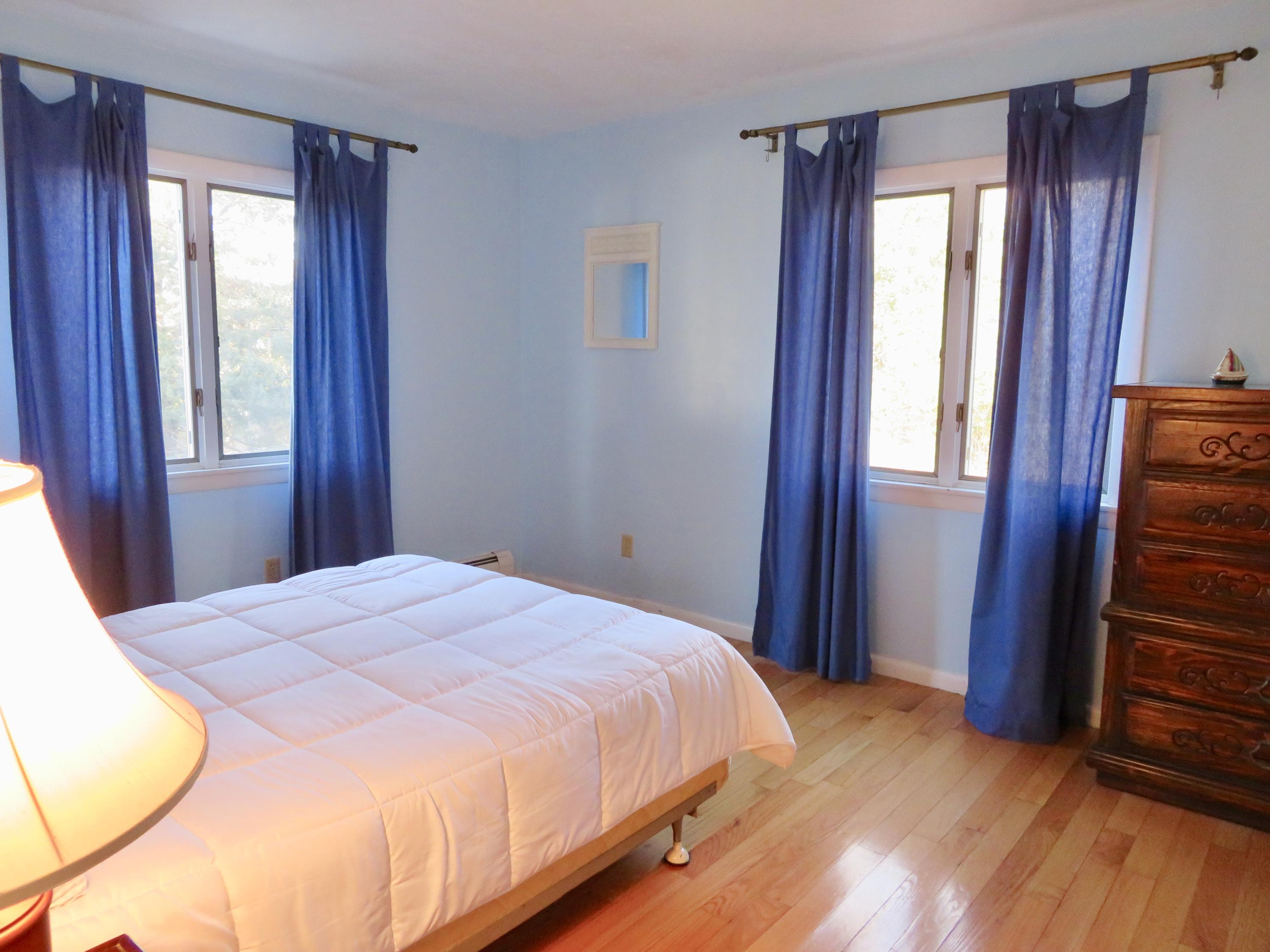 111 Elgin Road Pocasset, MA 02559 - Photo 12 of 34 a bedroom with a bed and wooden floor