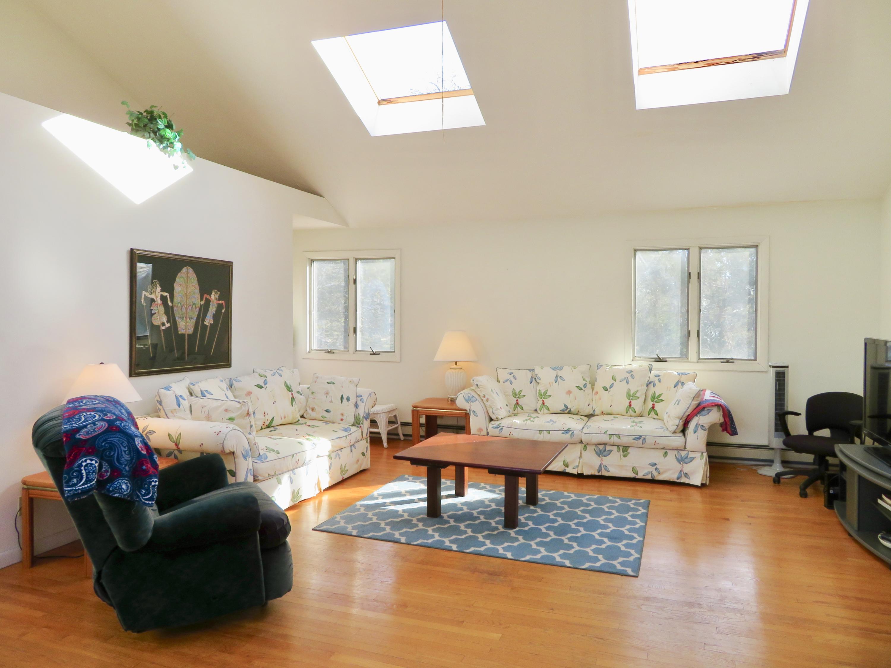 111 Elgin Road Pocasset, MA 02559 - Photo 16 of 34 a living room with furniture and a wooden floor