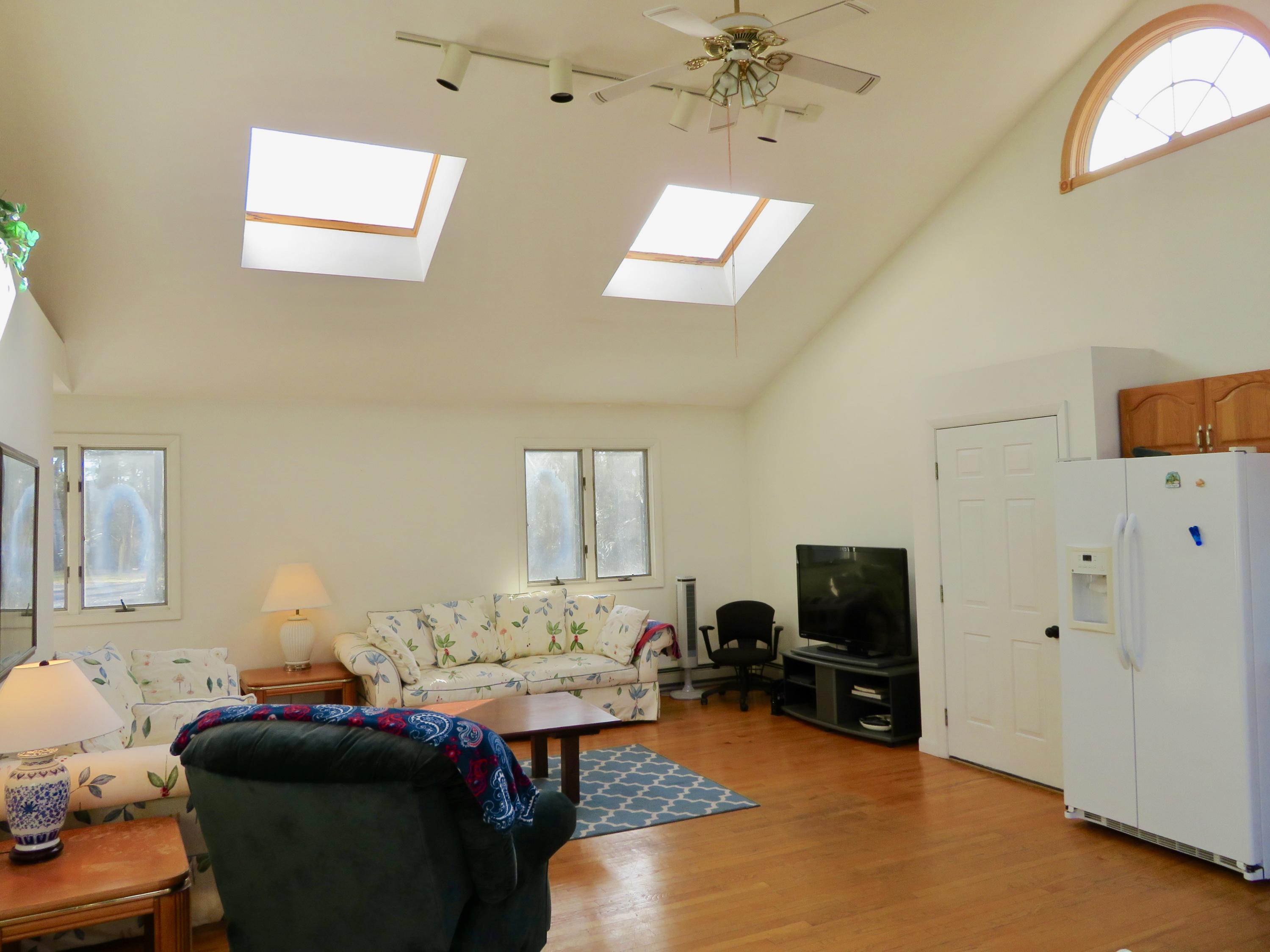 111 Elgin Road Pocasset, MA 02559 - Photo 17 of 34 a bedroom with furniture and a flat screen tv