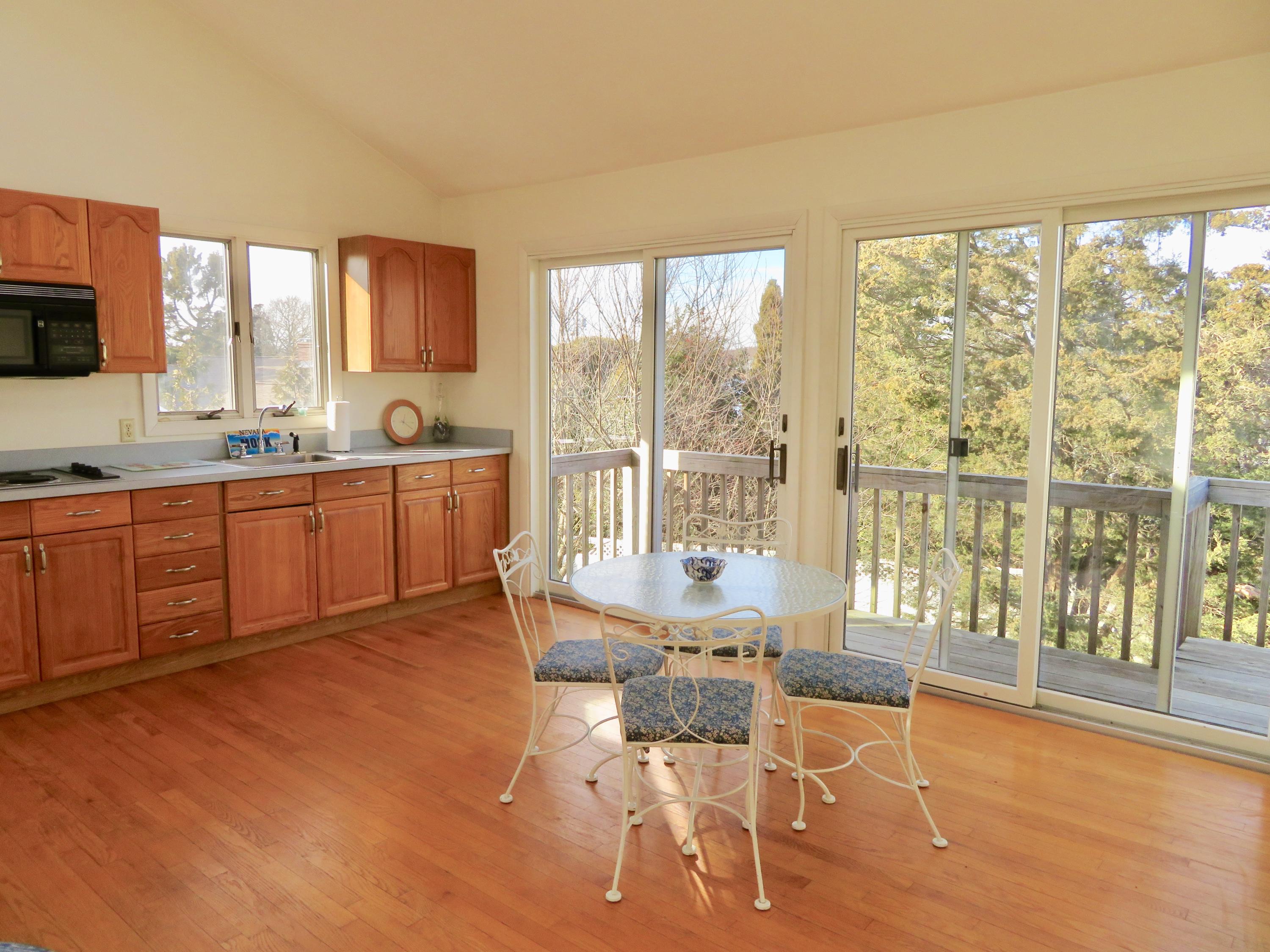 111 Elgin Road Pocasset, MA 02559 - Photo 18 of 34 a very nice looking living room with a large window and kitchen view