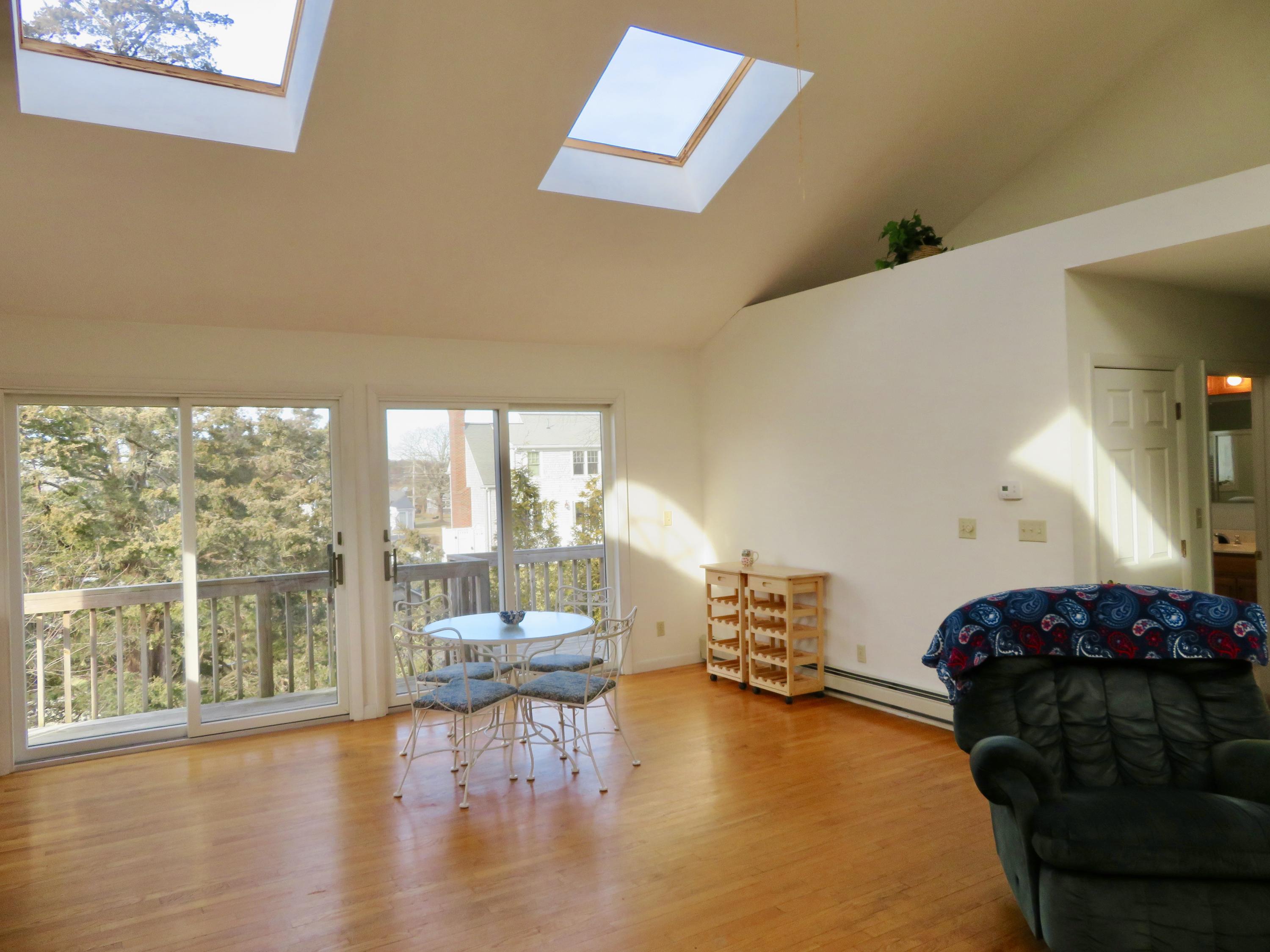 111 Elgin Road Pocasset, MA 02559 - Photo 20 of 34 a living room with furniture and a large window