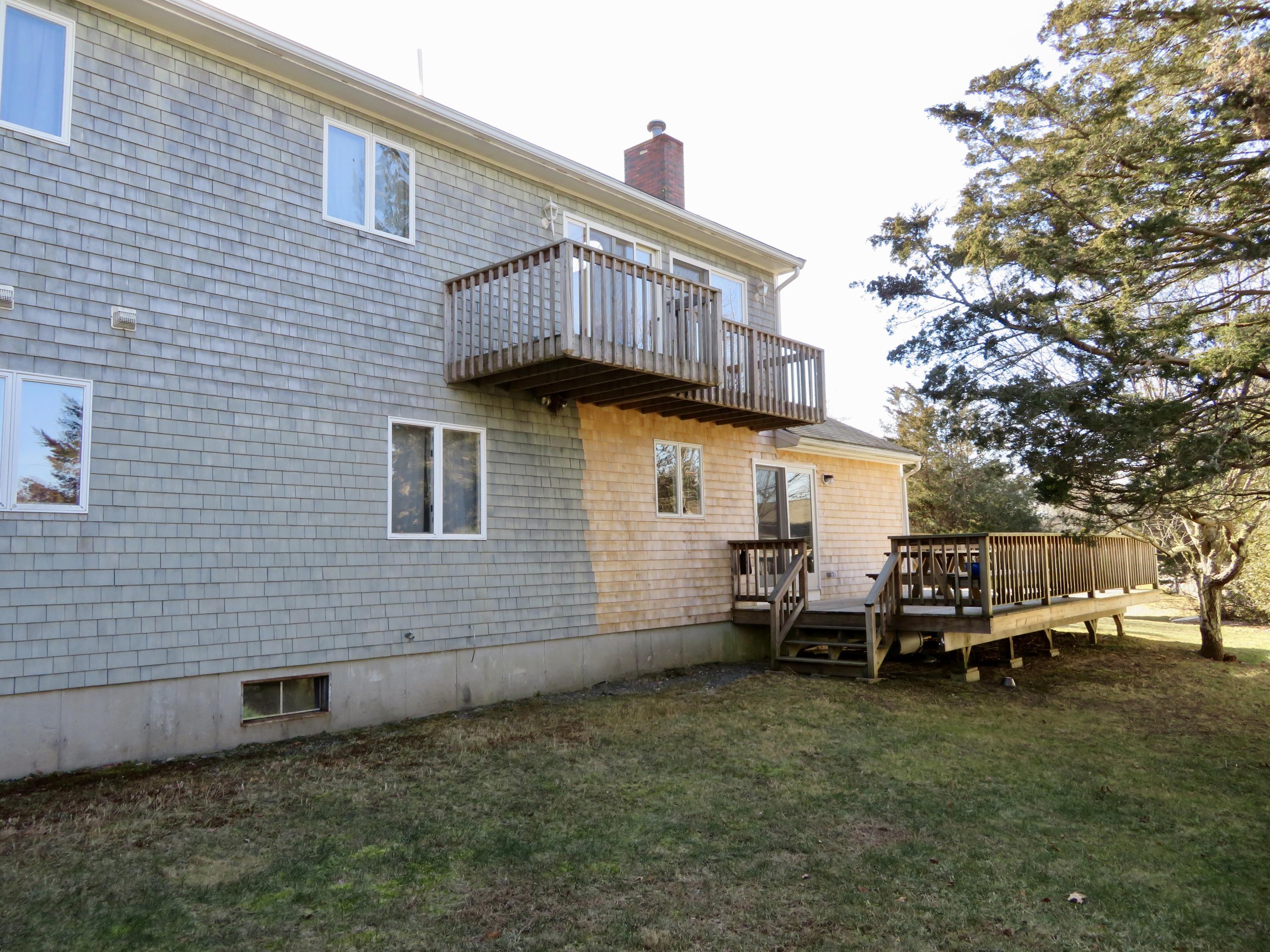 111 Elgin Road Pocasset, MA 02559 - Photo 26 of 34 a backyard of a house with table and chairs