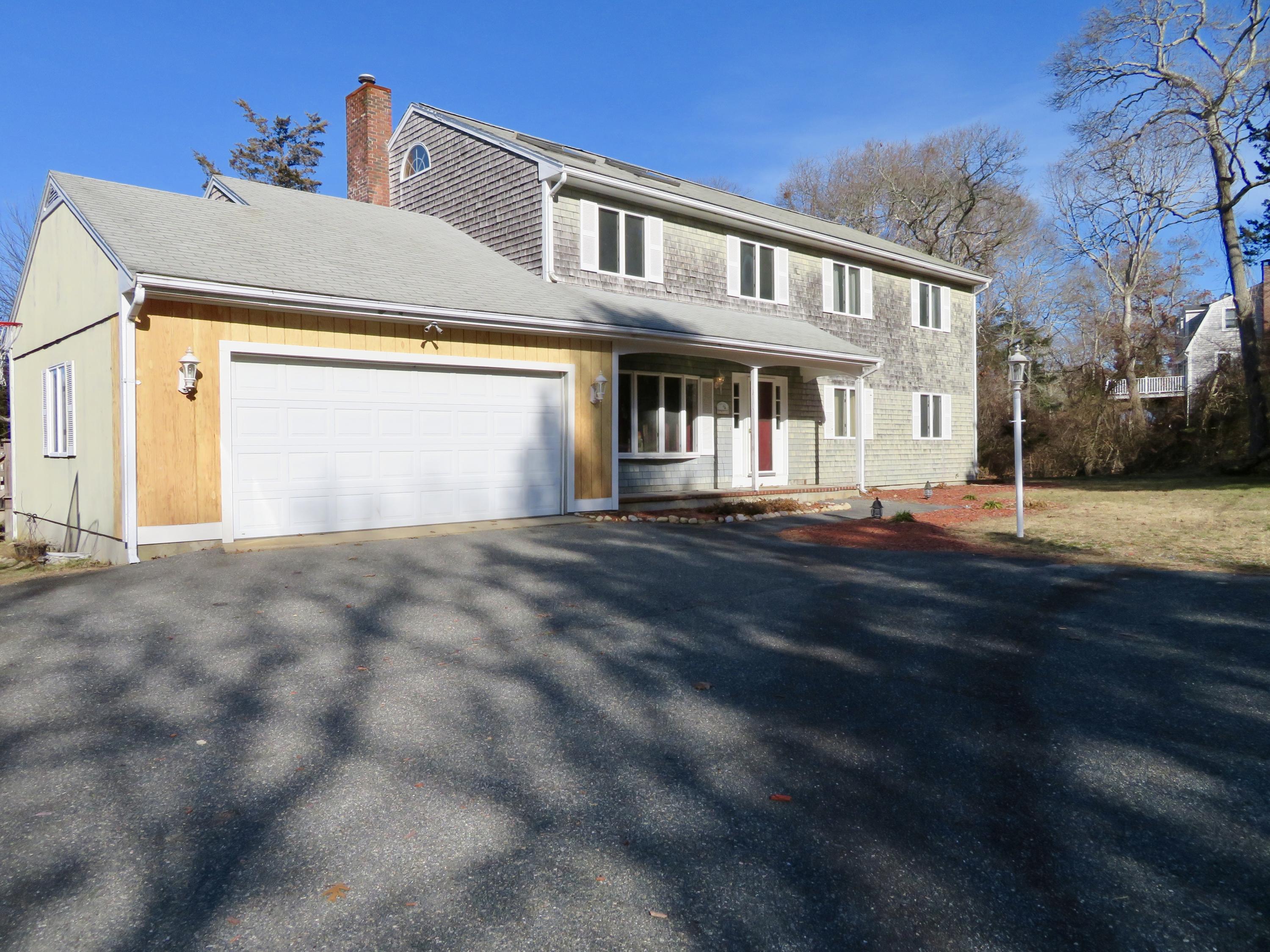 111 Elgin Road Pocasset, MA 02559 - Photo 28 of 34 a front view of a house with a yard