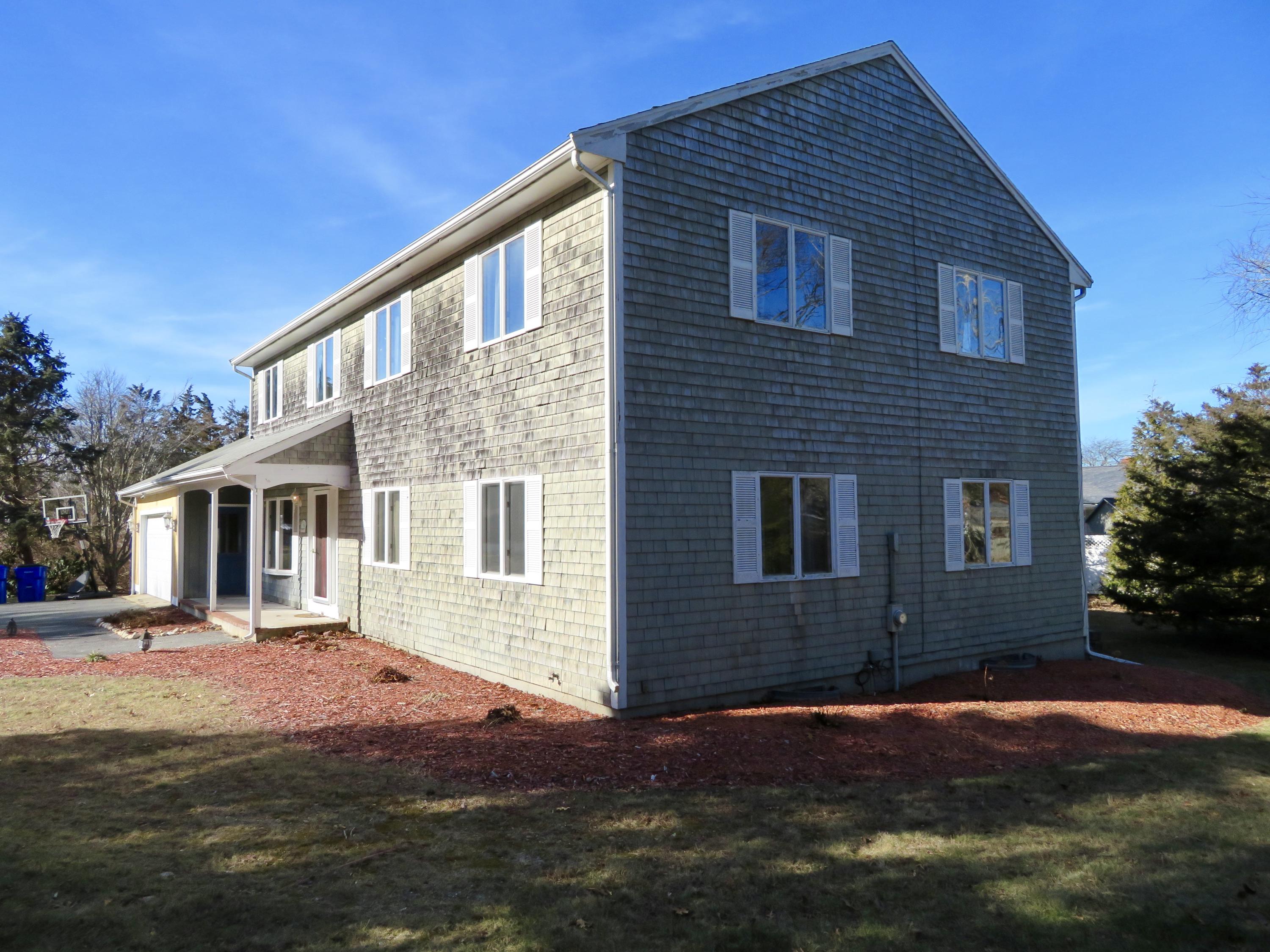 111 Elgin Road Pocasset, MA 02559 - Photo 29 of 34 a front view of a house with a yard