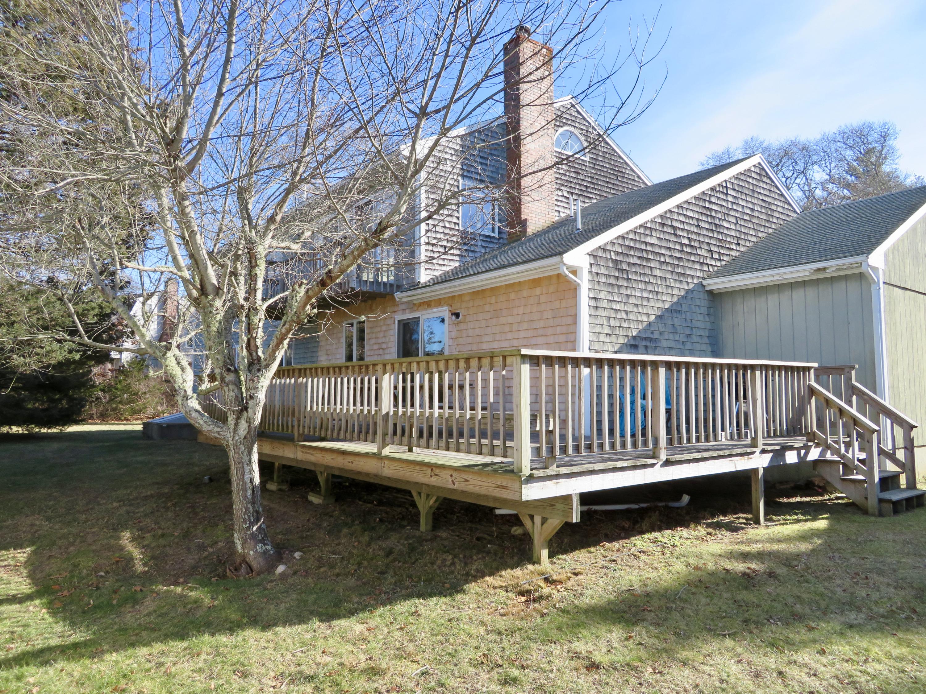 111 Elgin Road Pocasset, MA 02559 - Photo 4 of 34 a view of a wooden deck with a lake