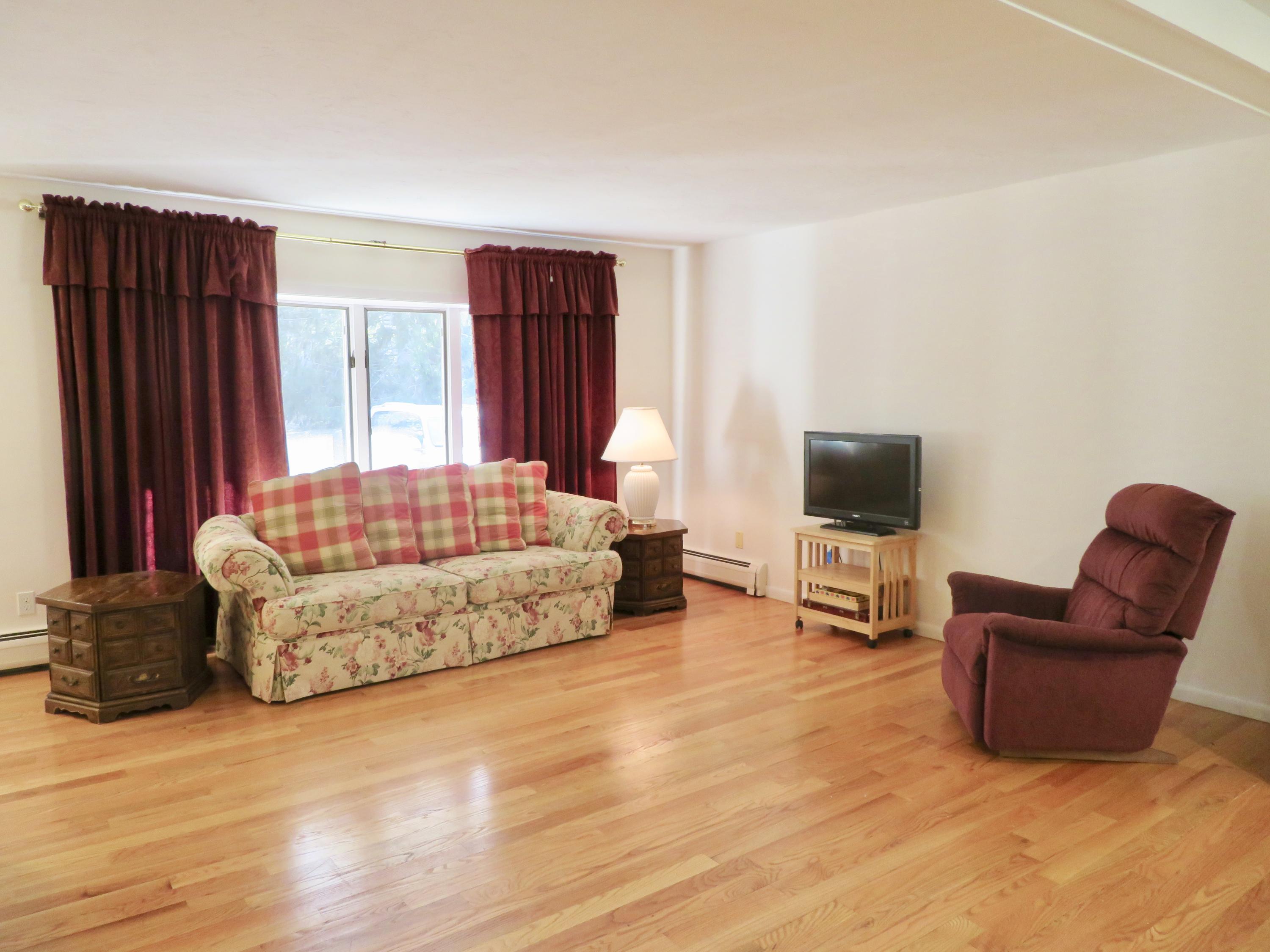 111 Elgin Road Pocasset, MA 02559 - Photo 9 of 34 a living room with furniture and a flat screen tv
