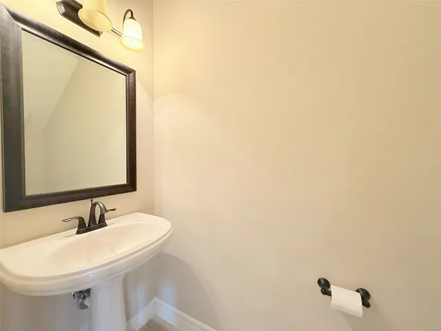 a view of a hallway with wooden floor and entryway