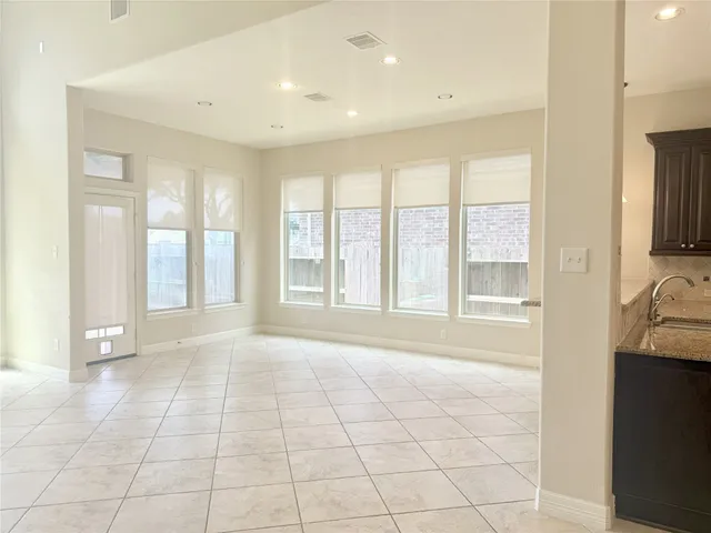 a large bathroom with a large mirror vanity and tiles