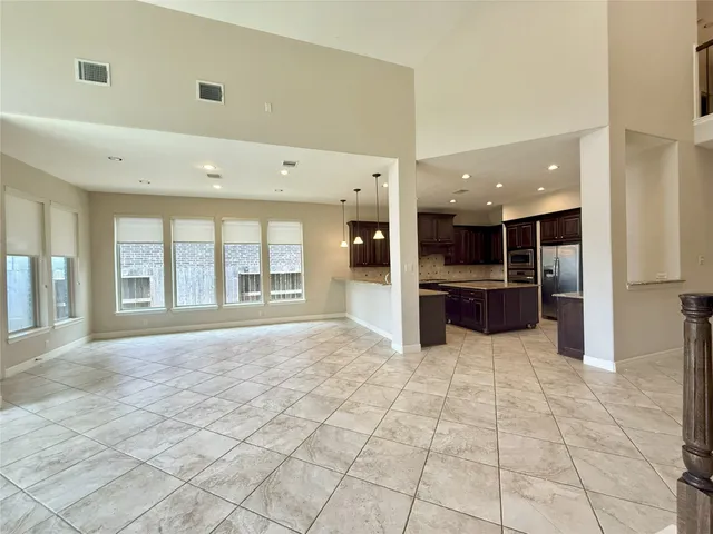 a kitchen with kitchen island granite countertop stainless steel appliances a sink stove and refrigerator