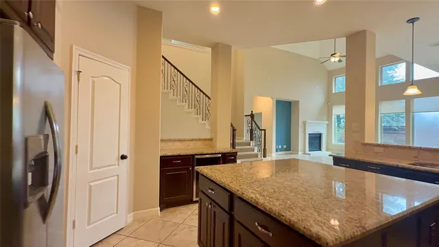a view of a kitchen from the hallway with seating area