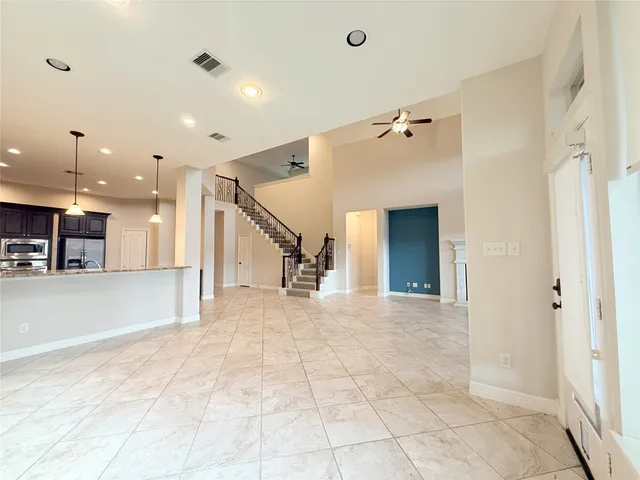 a spacious bedroom with a bed and a large window