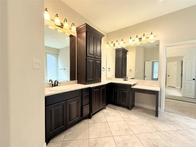 a spacious bathroom with a sink double vanity and a mirror