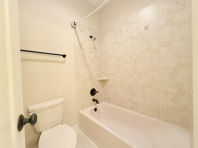 a bathroom with a double vanity sink a mirror and a bathtub