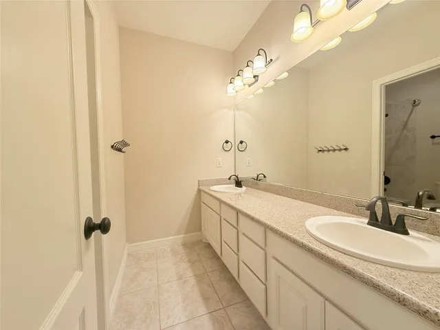 a large bedroom with a large bed and a chandelier