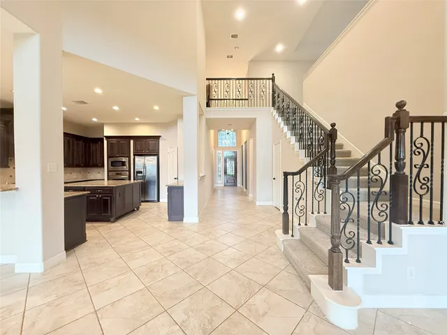 a view of a kitchen with kitchen island and stainless steel appliances