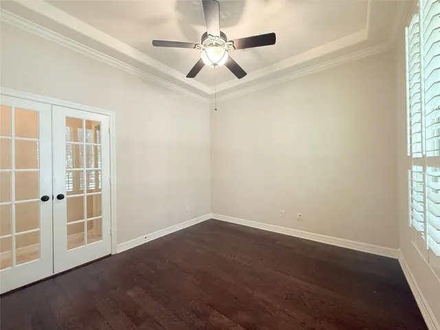a spacious bedroom with a bed and a chandelier