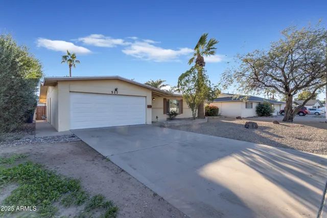 a view of a house with a yard and garage