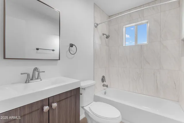 a bathroom with a sink a toilet and bathtub