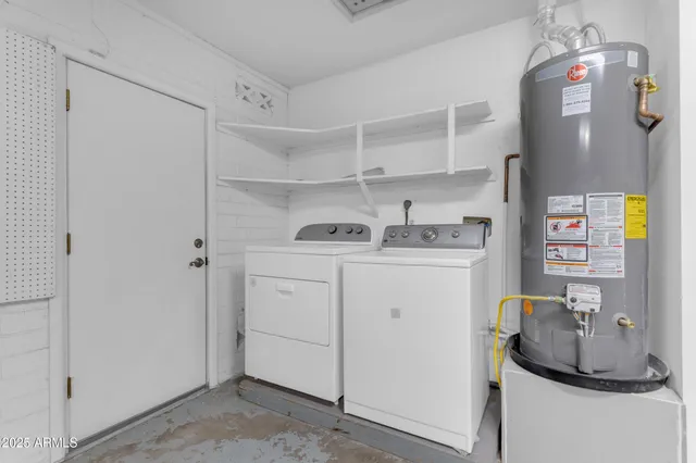 a utility room with cabinets washer and dryer