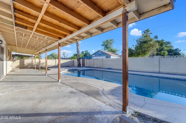 a view of a balcony with chairs potted plants and wooden floor