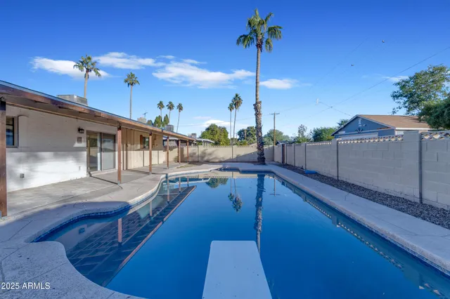 a view of a kitchen with kitchen island and living room