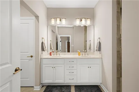 a bathroom with a double vanity sink and a mirror