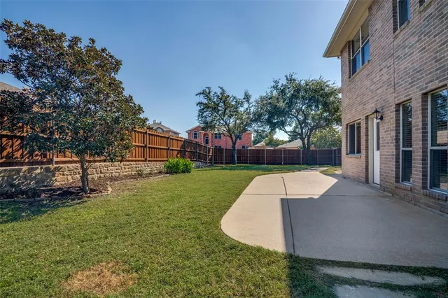 a view of a backyard with a garden and plants