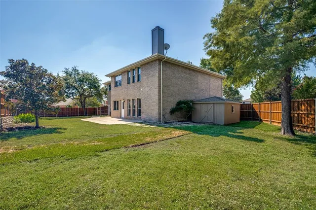 a front view of house with a garden