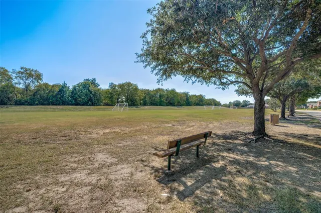 a view of a lake with a table and chairs