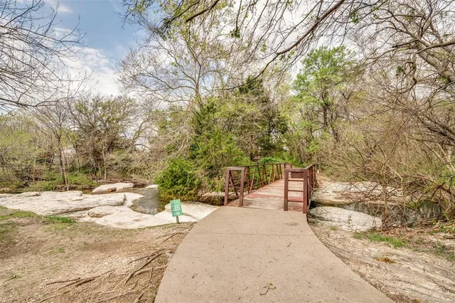 a view of a backyard with snow on the road
