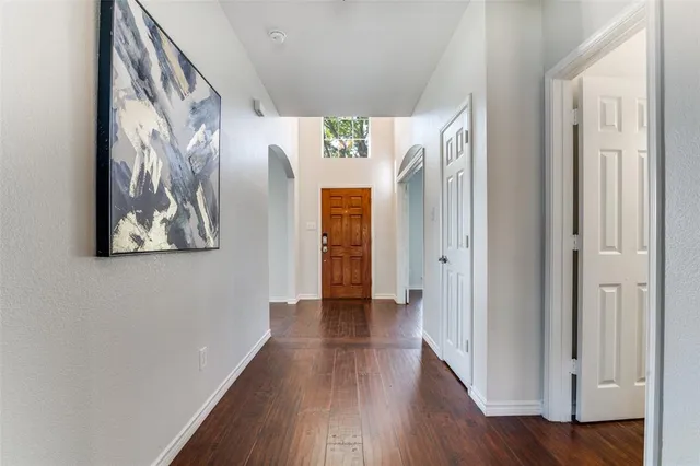 a view of hallway with wooden floor