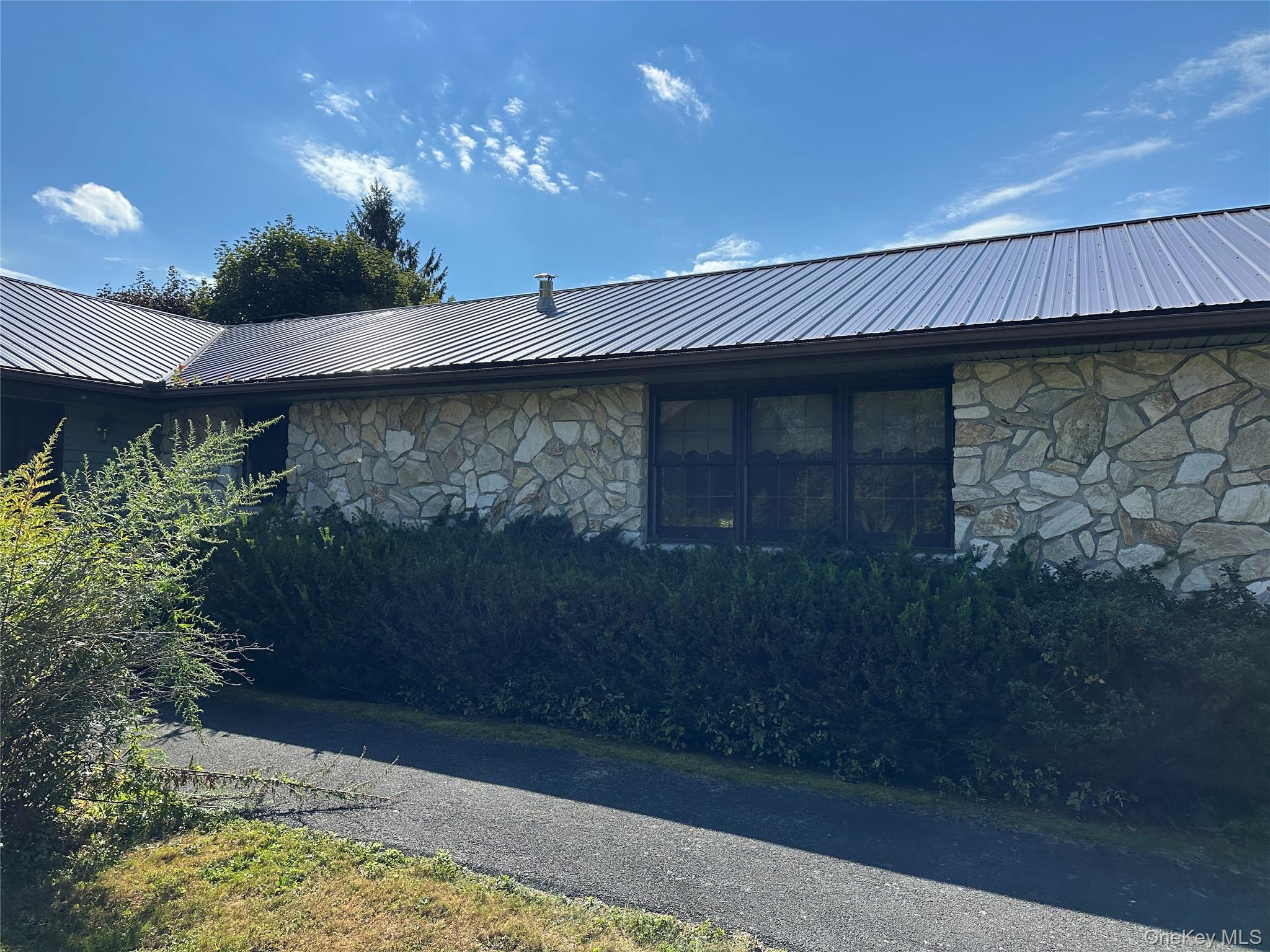 250 Rockland Road Roscoe, NY 12776 - Photo 12 of 32 Rear view of property with stone siding and a metal roof