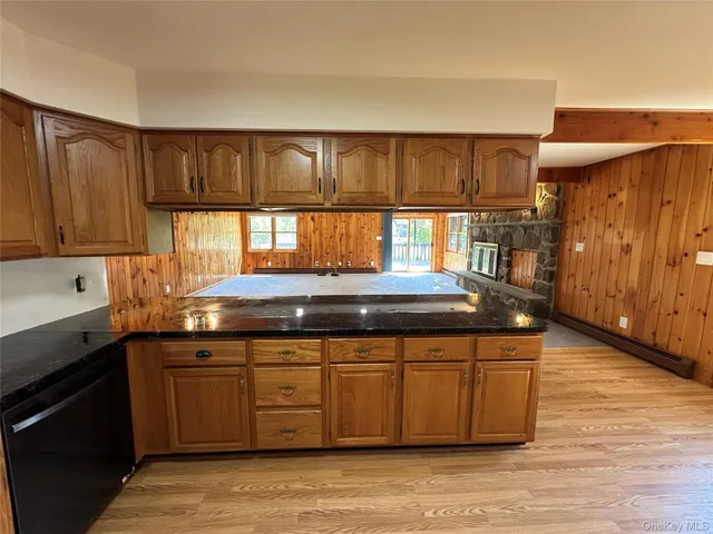 a kitchen with granite countertop a stove and cabinets